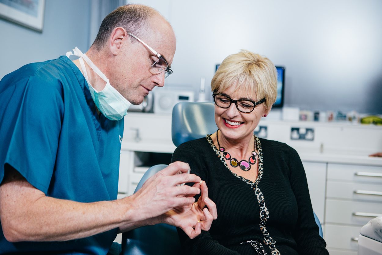 Dentist discussing dental implants with a patient at Bourne Dental Practice
